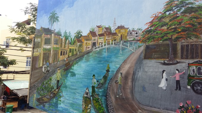 Peaceful view: A river in Đà Nẵng painted on the wall of a restaurant. — VNS Photo Công Thành Read more at http://vietnamnews.vn/sunday/480830/painting-team-brighten-up-cafes-in-da-nang.html#526RGlR6vLvJjLuP.99