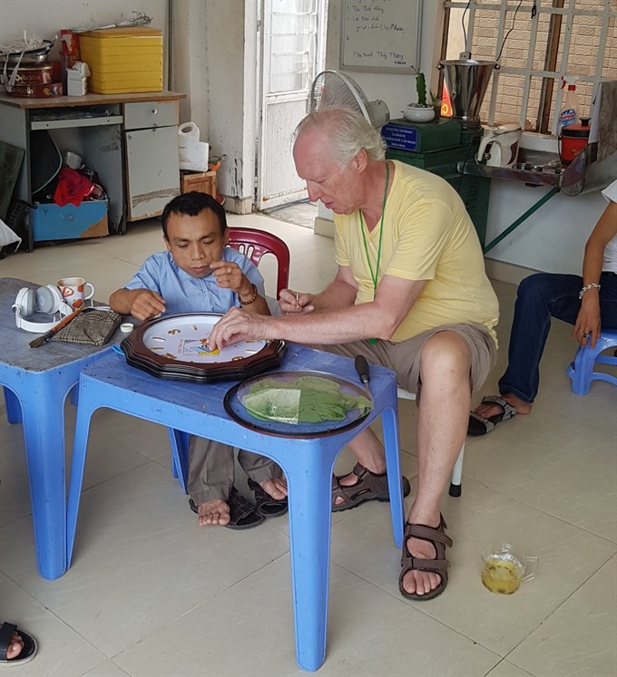 Helping hand: Keenan provides care at DAVA’s centre. Read more at http://vietnamnews.vn/life-style/expat-corner/481412/american-vet-finds-peaceful-home-in-da-nang.html#7TkySf5ACT6xpY76.99