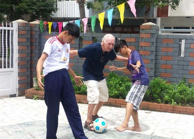 Kick about: Keenan plays football with children at DAVA’s centre.  Read more at http://vietnamnews.vn/life-style/expat-corner/481412/american-vet-finds-peaceful-home-in-da-nang.html#7TkySf5ACT6xpY76.99