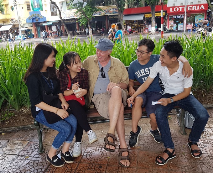 Lakeside chat: Keenan helps Vietnamese students practise their English by Hoàn Kiếm Lake in Hà Nội. Read more at http://vietnamnews.vn/life-style/expat-corner/481412/american-vet-finds-peaceful-home-in-da-nang.html#7TkySf5ACT6xpY76.99