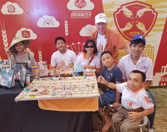 For sale: Matthew Keenan (standing) sells handmade DAVA products at a fundraiser. Read more at http://vietnamnews.vn/life-style/expat-corner/481412/american-vet-finds-peaceful-home-in-da-nang.html#7TkySf5ACT6xpY76.99