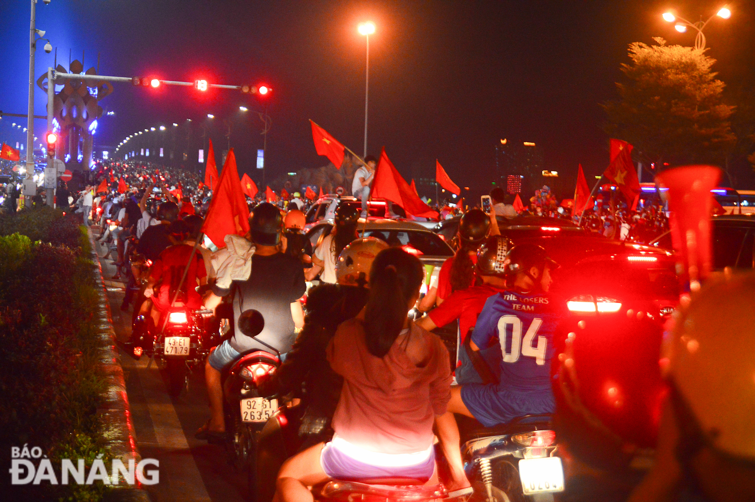 Local streets crowded with football fans with national flags.