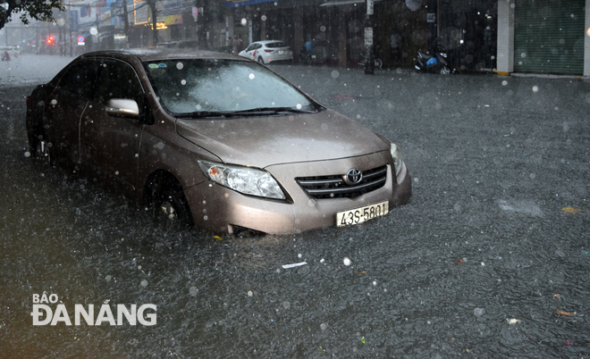 A car submerged under massive volume of rainwater