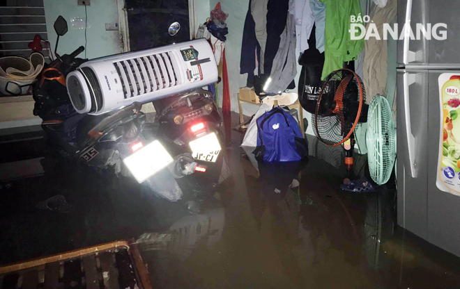 Floodwater flows into a local residential house on Phan Chau Trinh Street
