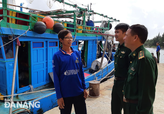 Local border guards giving encouragement to local fishermen prior to their fishing trips