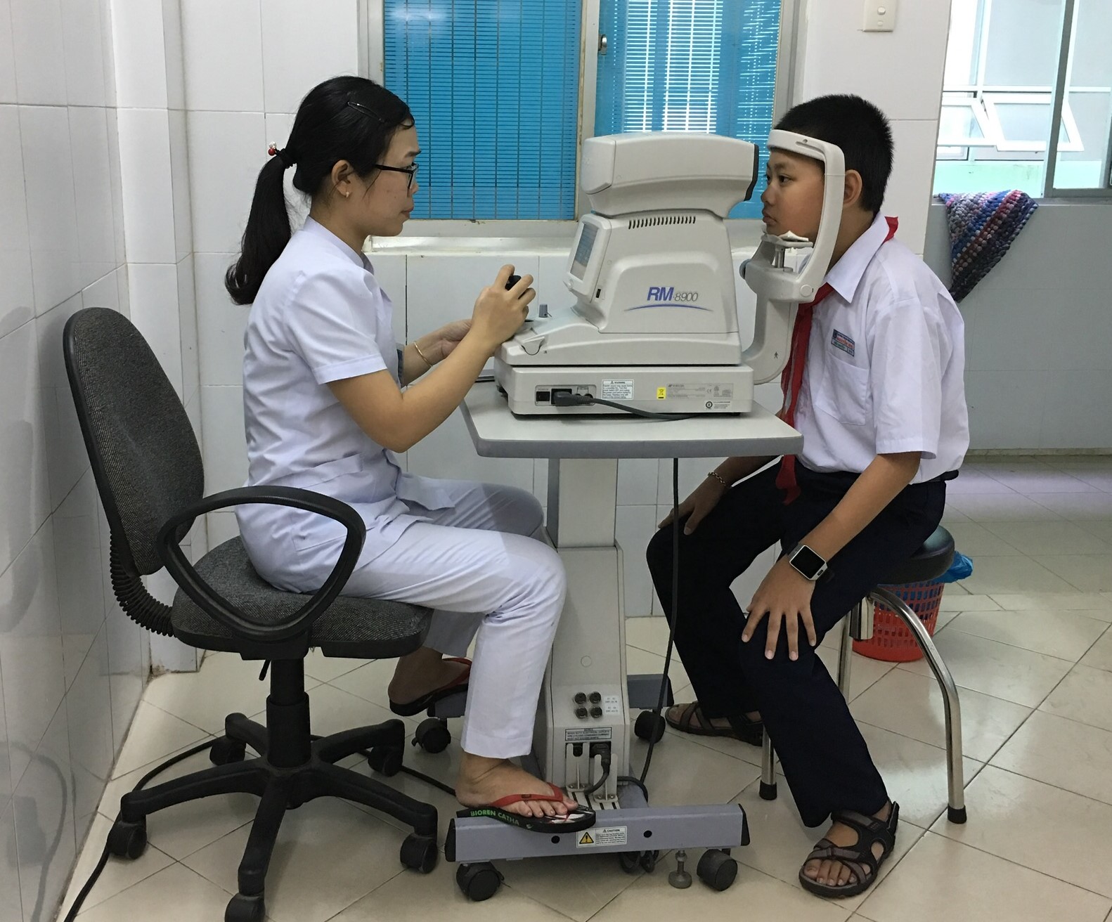 A junior high school pupil receiving free eye examinations.