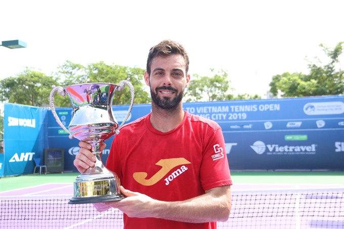 Marcel Granollers from Spain lifts the trophy at the Việt Nam Tennis Open Đà Nẵng City 2019 on January 12. He cruised to a 6-2, 6-0 win over Italian Matteo Viola in the men’s singles final. — Photo courtesy Việt Nam Tennis Federation Read more at http://vietnamnews.vn/sports/483702/marcel-wins-viet-nam-open.html#GyEzEjfvk7sqwyF0.99