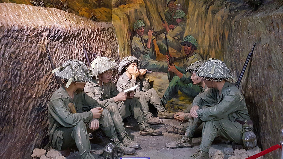 Dien Bien Phu soldiers sitting in tunnel.