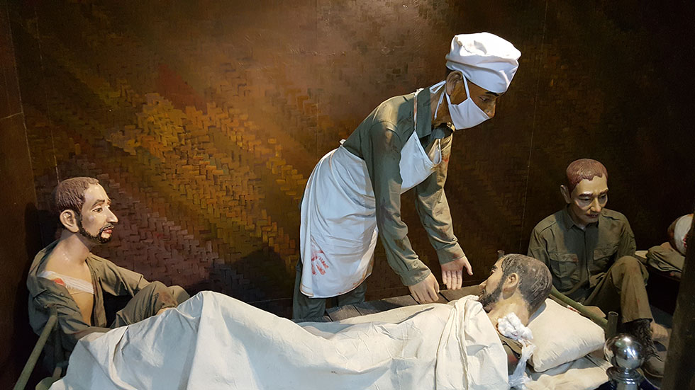 A Vietnamese doctor giving medical treatment to French soldiers on the Dien Bien Phu battlefield.