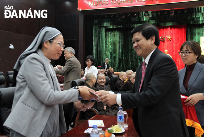 People's Council Chairman Trung giving a Tet gift to a local religious dignitary.