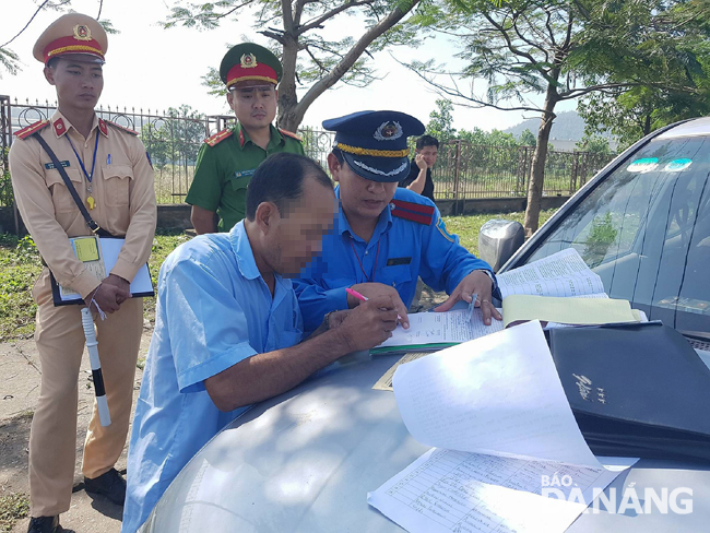 Traffic police officers handling a traffic violator.