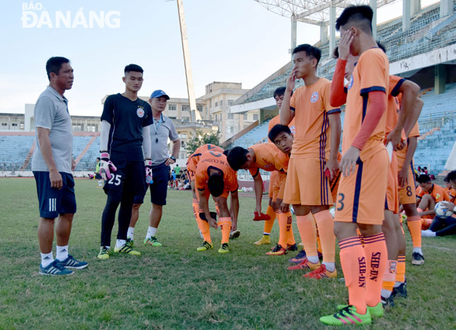 Deputy Director Hung and some local young footballers.