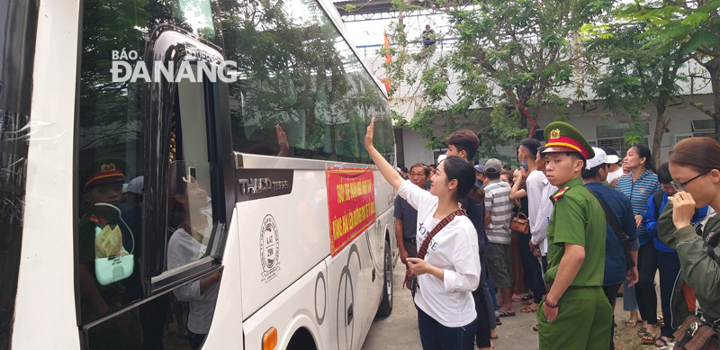 A girl saying goodbye and waving to her best friend sitting on a coach.