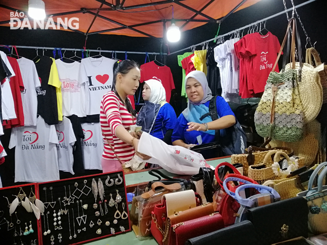 It is necessary to develop new unique tourism products. Tourists are pictured buying  souvenirs at Son Tra night market.