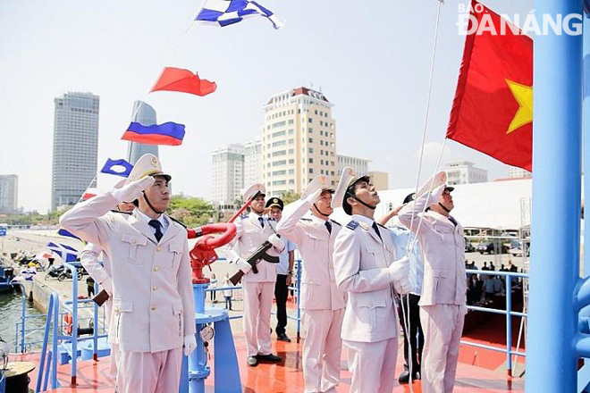 A flag-raising ceremony onboard the high-speed patrol boat HQ 11- 91- 63