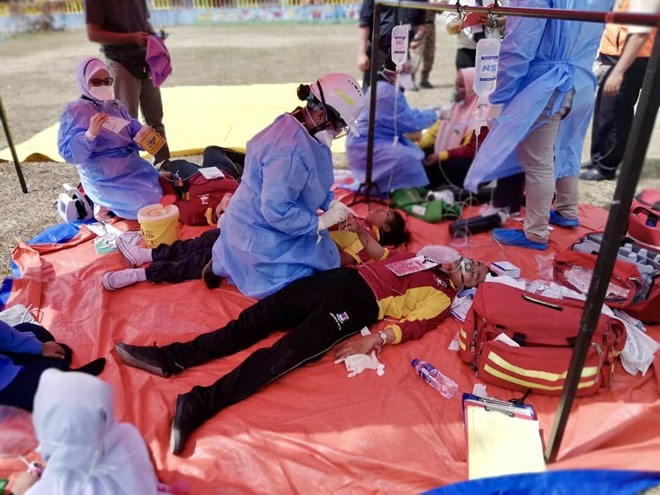 Rescue personnel rendering immediate emergency assistance to students who breath in hazardous gas. (Photo: Johor Fire and Rescue Department)