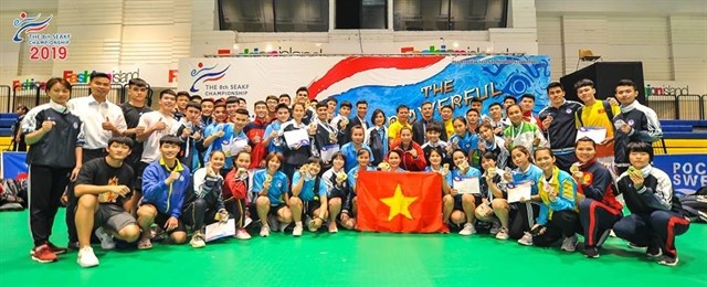 Vietnamese athletes pose for a group photo after winning the eighth Southeast Asian Karate Federation Championship in Bangkok, Thailand. (Photo: Thailand Karate Federation)