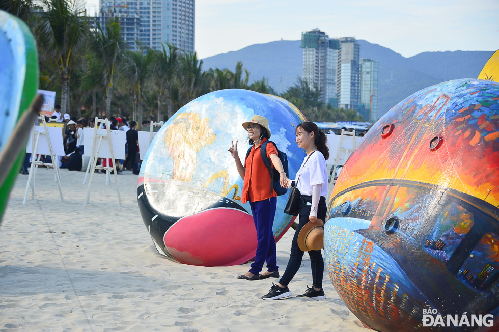 Young people are eager to pose for photos with colourful coracles