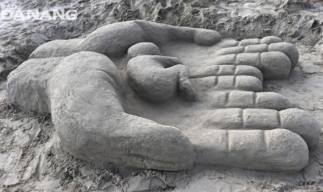 A sand sculpture conveying a message of protecting people through nature