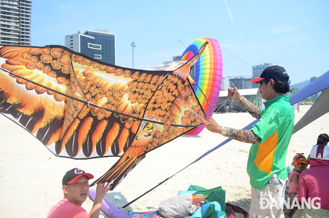 A large kite being ready to fly in the sky