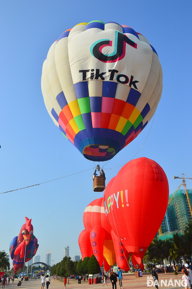  Some take jaunts into the skies, while others enjoy the event from the ground, taking photos of the balloons soaring high in the sky