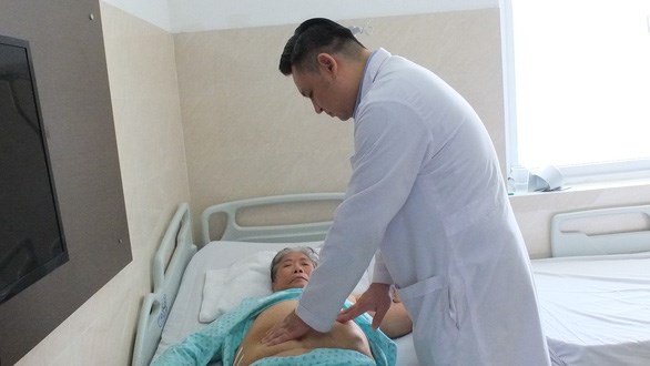 A doctor gives examination to the patient after the surgery at Binh Dan Hospital in HCM City (Photo courtesy of Binh Dan Hospital)