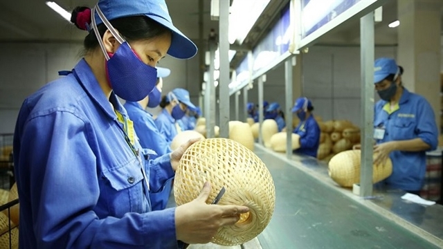 Workers check products. A fund for development of SMEs will be opened this year. — Photo theleader.vn