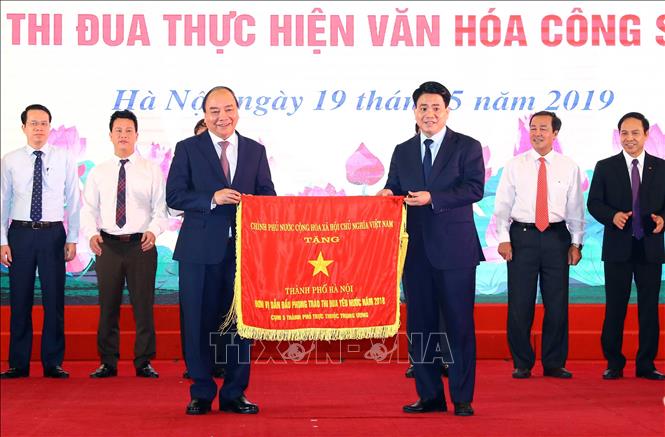 Thủ tướng Nguyễn Xuân Phúc trao cờ thi đua của Chính phủ cho thành phố Hà Nội. Ảnh: Thống Nhất/TTXVN