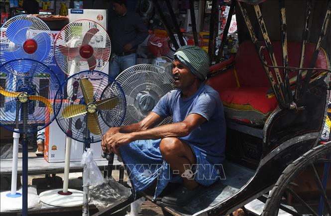 Người dân dùng quạt để tránh nóng tại Kolkata, Ấn Độ, ngày 8/4/2019. Ảnh: AFP/TTXVN