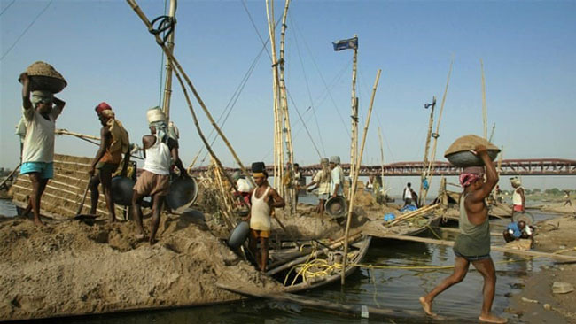 Lao động vận chuyển cát từ sông Yamuna ở Ấn Độ.