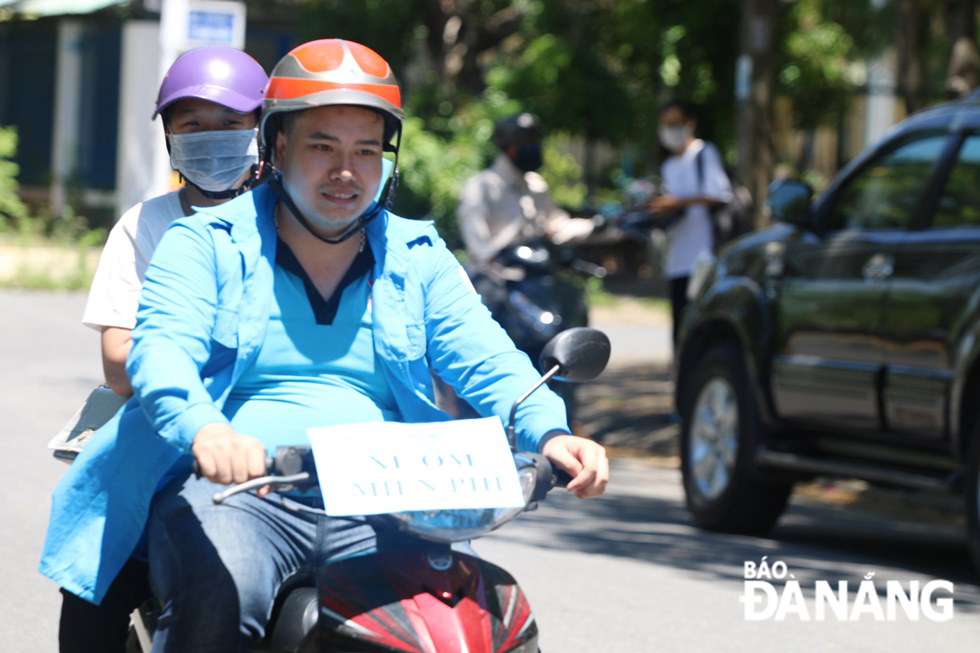 A motorbike taxi driver taking an exam candidate to her home to prepare for the afternoon exams