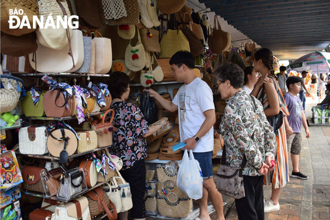 Holiday- makers are seen going shopping at the downtown tourists-packed Han Market