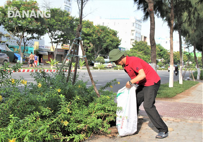 A disable person picking up rubbish