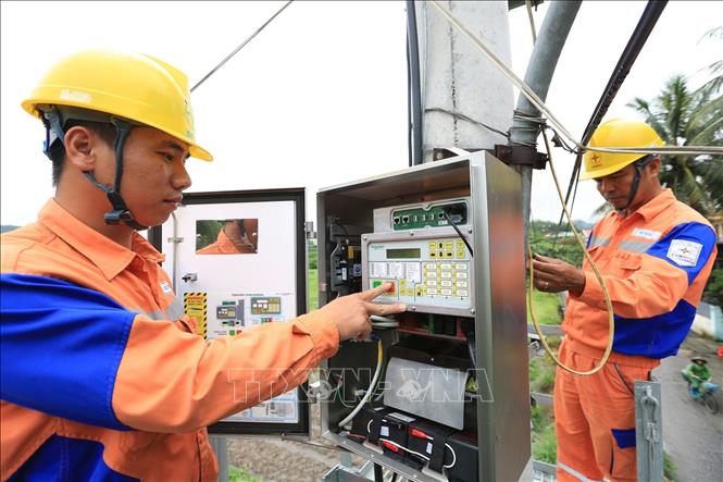 Công nhân Công ty Điện lực Quảng Ninh (Tổng Công ty Điện lực miền Bắc) lắp đặt thiết bị truyền dữ liệu đáp ứng việc thực hiện CMIS. Ảnh: Ngọc Hà/TTXVN