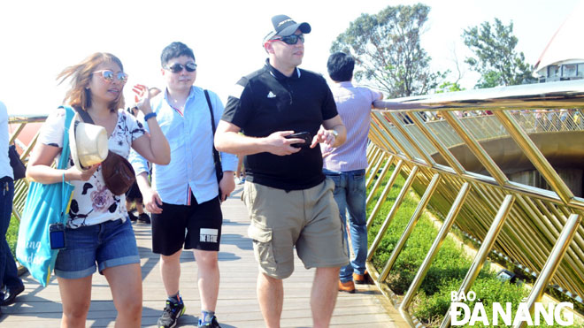  Holiday-goers from Thailand, and Southeast Asia as a whole, like to experience new tourism products. Visitors are pictured visiting the Golden Bridge at the Sun World Ba Na Hills