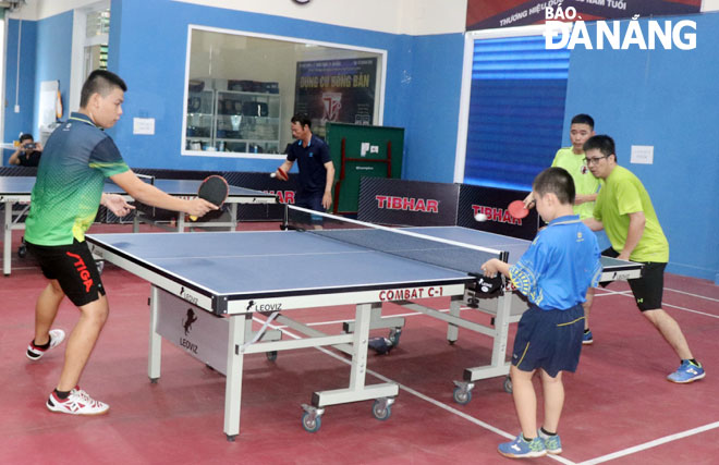 Local residents playing table tennis at the Culture and Sports Centre in Thanh Khe Dong Ward