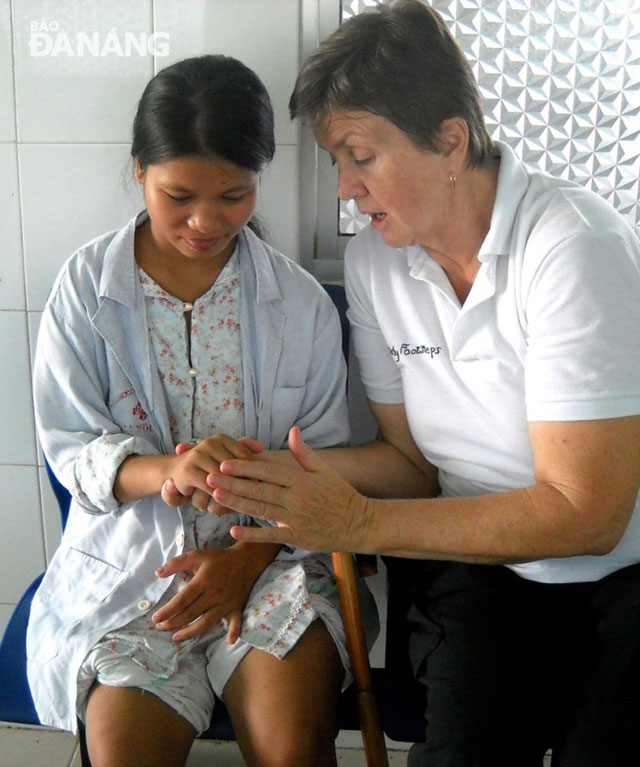 Mrs Lockett enthusiastically offering a patient hand rehabilitation