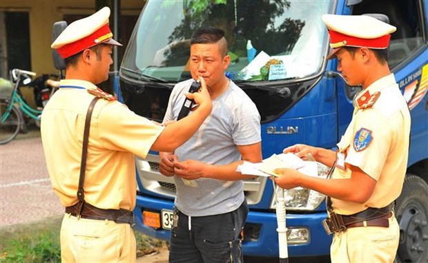 Lực lượng Cảnh sát giao thông huyện Nho Quan kiểm tra nồng độ cồn với lái xe. (Ảnh: Minh Đức/TTXVN)