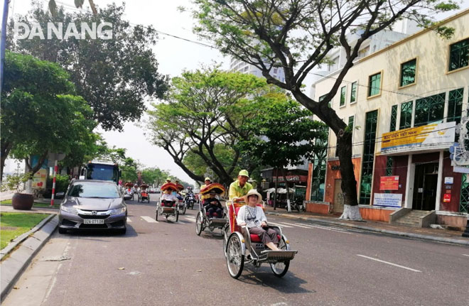 Foreigners enjoying a city tour by cyclo