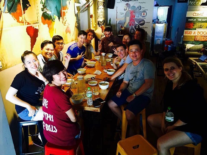 Visitors at the Barney's Danang BackPackers Hostel enjoying food together