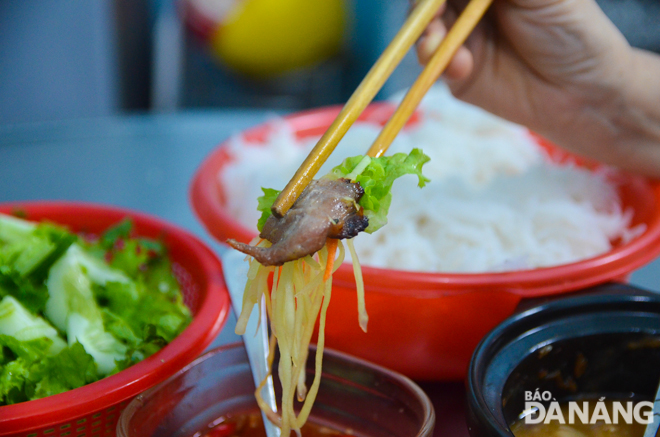 The delicious dish is served with pickled carrots and green papaya