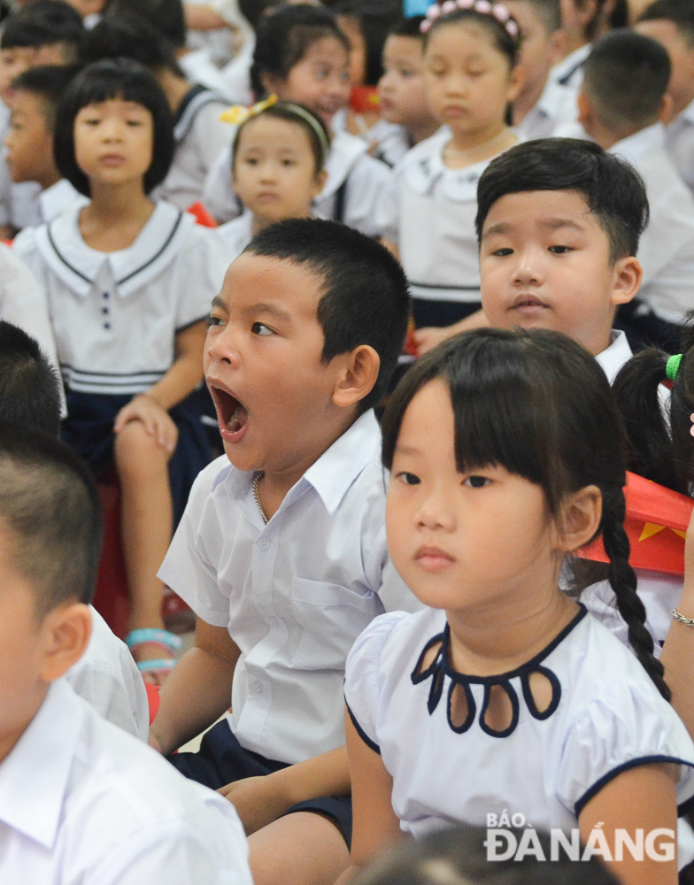 A boy is seen yawning drowsily after having woken up so early in preparation for the school-year opening ceremony