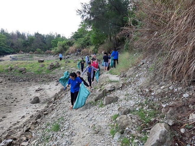 Youth Union members are pictured collecting litter at the Xanh Lake