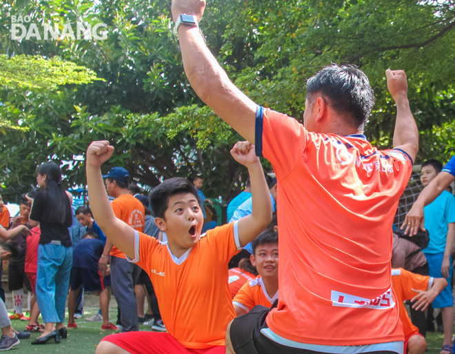 A kid sharing the joy of winning with his coach