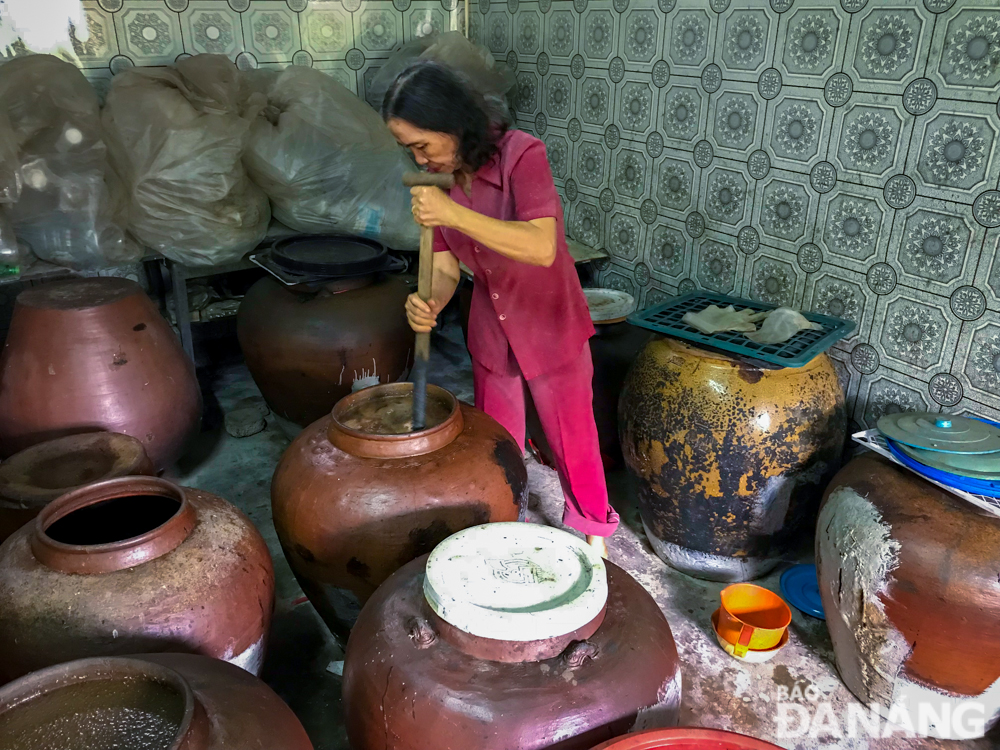 Here are dozens of over clay jars of fish sauce at a family-run establishment 