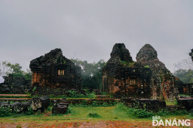 Ancient towers appearing in the rain and fog, plus in the green of trees and deep brown of old bricks remind visitors about the distant history of the My Son Sanctuary.