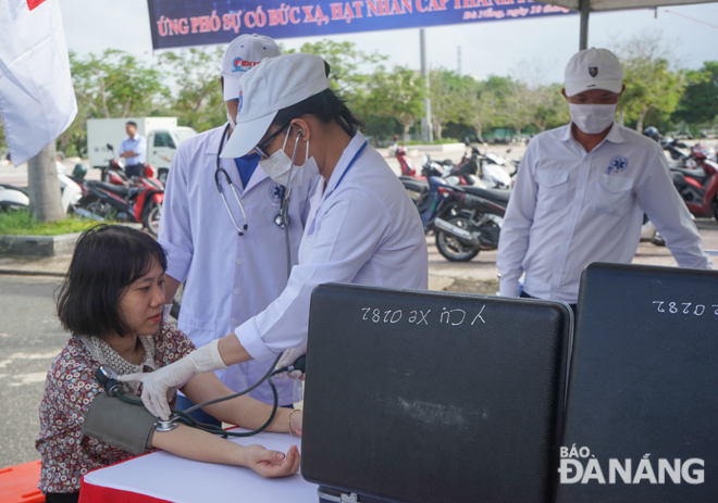 Medical workers giving medical examinations to a resident living in areas suspected of being contaminated with radiation.