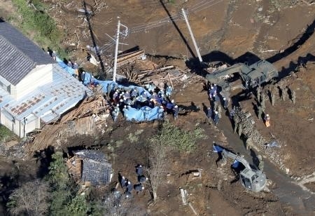 Rescue workers search for victims of a landslide caused by Hagibis in Tomioka Province in Japan. 