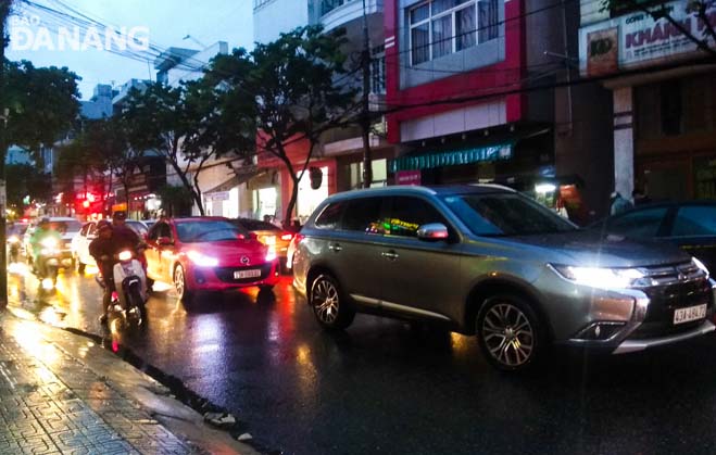 Cars being bumper to bumber  along a section of downtown Hai Phong