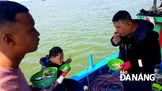 Fishermen having lunch on their boat